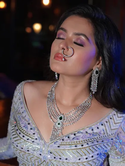 A close-up on the dramatic eye makeup and glossy lip, a perfect combination for a reception or cocktail party.