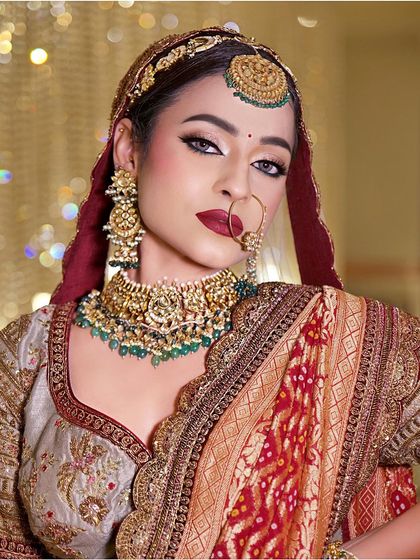 A canvas of beauty. This classic Indian bride look features a bold red lip and dramatic winged eyeliner, creating a look that is both stunning and inspiring.