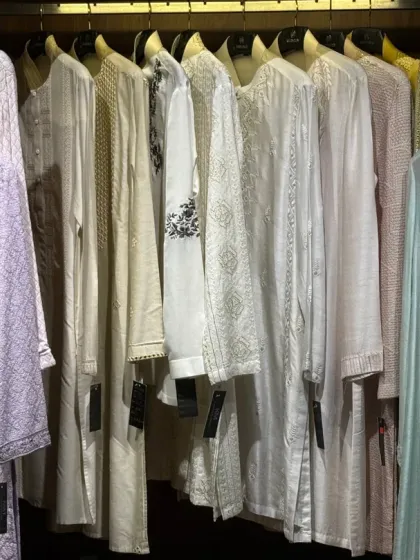 A view of my collection of bespoke kurtas on the rack. This image shows the variety of textures, colors, and embroidery styles I offer, from subtle geometrics to intricate threadwork, each one ready to be tailored.