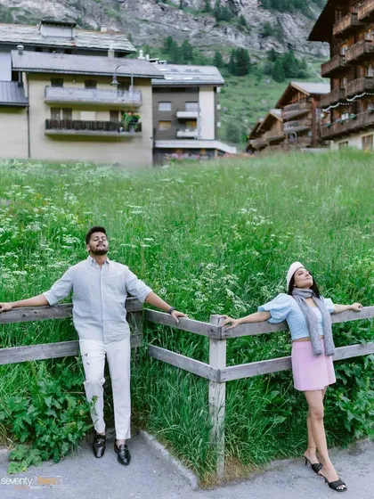 Leaning against a rustic fence in a field of wildflowers, they soak in the alpine air. A relaxed, candid portrait that captures the peaceful, romantic vibe of Zermatt.