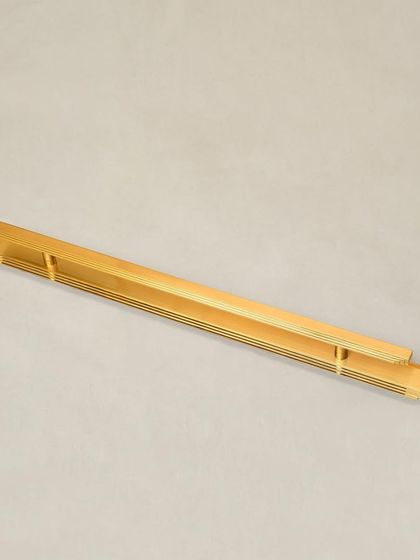 A full-length view of the Natali door pull with a long backplate, emphasizing its sleek, architectural form.