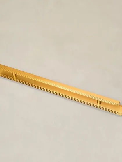 A full-length view of the Natali door pull with a long backplate, emphasizing its sleek, architectural form.