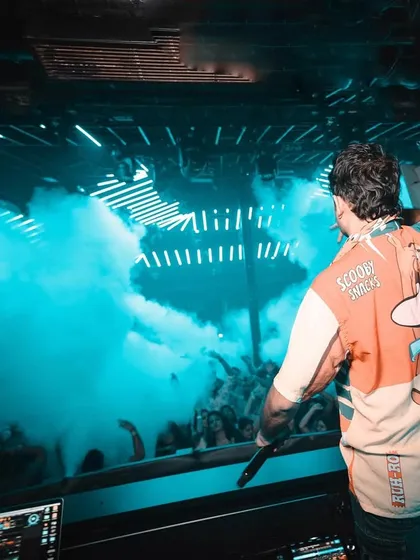 Rocking a Scooby-Doo jersey while overlooking a sea of people and smoke in Goa.