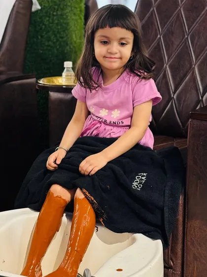 Pampering is for everyone, even our youngest clients. Here's a little one enjoying our special Pedi Café treatment, which uses a gentle, coffee-based formula that smells amazing and leaves skin feeling super soft.