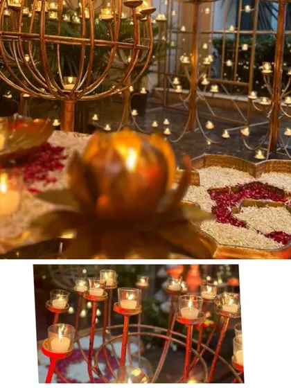 Lighting is key to creating a sacred vibe. Here, you can see the hundreds of candles and diyas I use in my designs, from large candelabras to small lotus shaped holders, all contributing to a warm and divine glow.