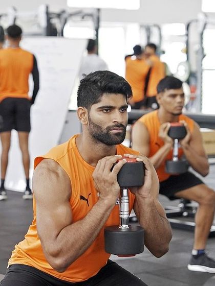 Focus and form are everything. Here, an athlete executes a dumbbell goblet squat, an excellent exercise for building leg strength while maintaining an upright torso.