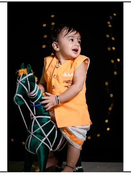 A classic studio portrait of a toddler enjoying a prop horse against a dark backdrop with soft lighting. My studio sessions are perfect for creating timeless and focused child portraits.