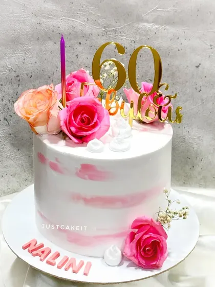 A "60 & Fabulous" cake with a soft pink watercolor finish and fresh roses. It's a simple, beautiful, and elegant way to celebrate a milestone.