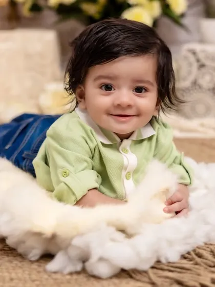 A pure and simple smile that lights up the room. This tummy time shot on a bed of soft clouds captures the innocent joy of a baby discovering the world around them.