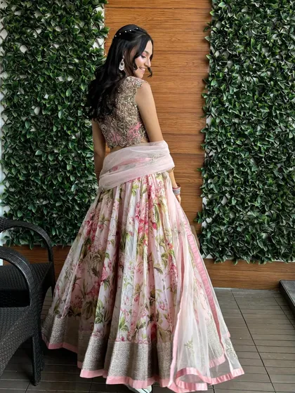 The playful and famous Anushree Reddy floral lehenga. This piece is a favorite for mehendi functions or daytime weddings with its beautiful print and light, airy feel.