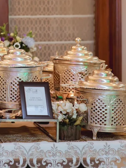A wider angle of the silver-plated chafing dishes, showcasing a cohesive and regal look for a special event. The setup is both functional and a beautiful decorative element.
