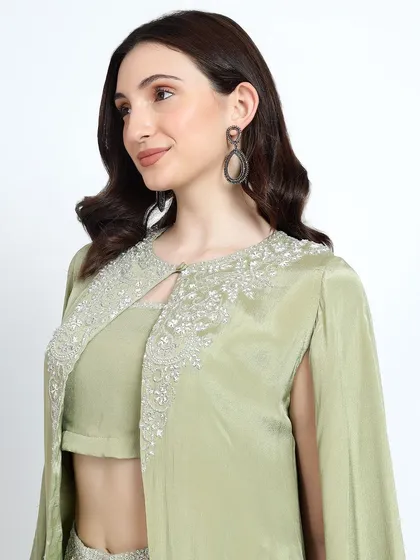 A close-up of the embellished cape from the mint green dhoti set, showcasing the delicate silver beadwork.