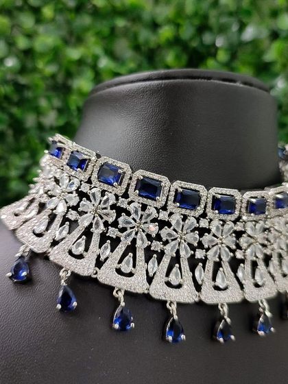 A close-up of the necklace, showing the beautiful contrast between the deep blue stones and the sparkling white AD stones.