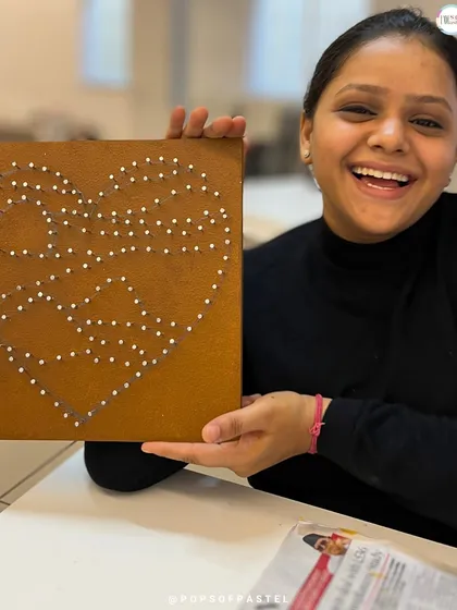 The initial stage of a string art project, with all the nails hammered in place, ready for the colorful threads to be woven.