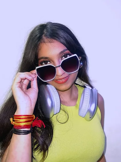 Rocking sunglasses and a confident smile. This close-up shot is full of personality and sass.