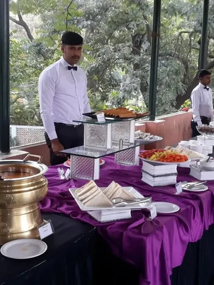 Our professional staff, dressed in smart uniforms with bow ties, are ready to serve at an outdoor event. We pride ourselves on providing polite and attentive service.
