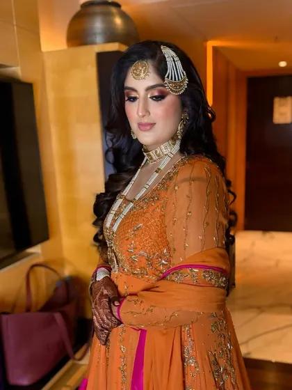 A close-up of the bride's regal look, her hair styled in classic, glamorous waves.