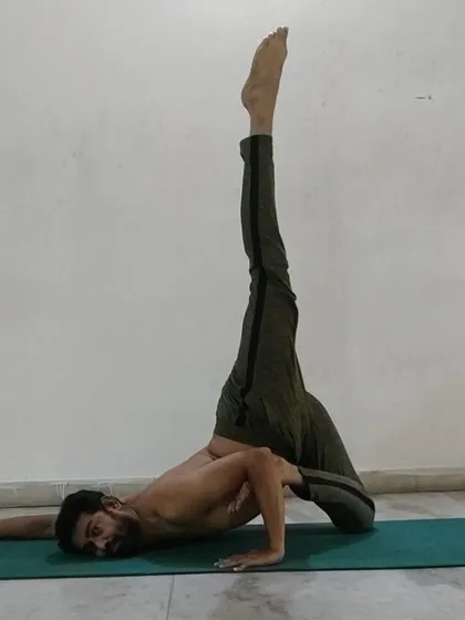 An advanced side-lying leg-lift pose that deeply stretches the hamstrings and hips while challenging your balance and core stability.