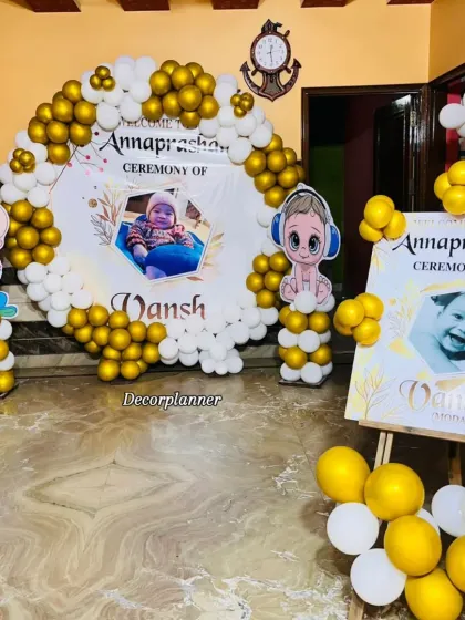 Another angle of the modern Annaprashan decor, showing how the balloon pillars and the main arch create a complete and immersive photo zone for the family.