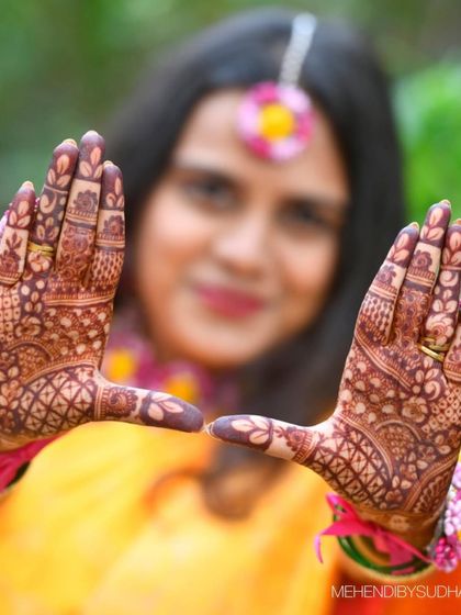 A close-up shot focusing on the rich stain of the intricate patterns on the bride's palms.