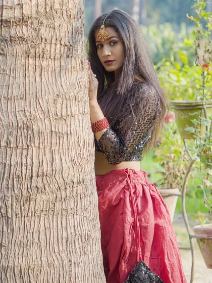 This outdoor fashion shot shows how I use natural light and surroundings to create a striking, editorial look. The model is wearing an ethnic fusion outfit with a sequined top and red skirt, perfect for a modeling portfolio.
