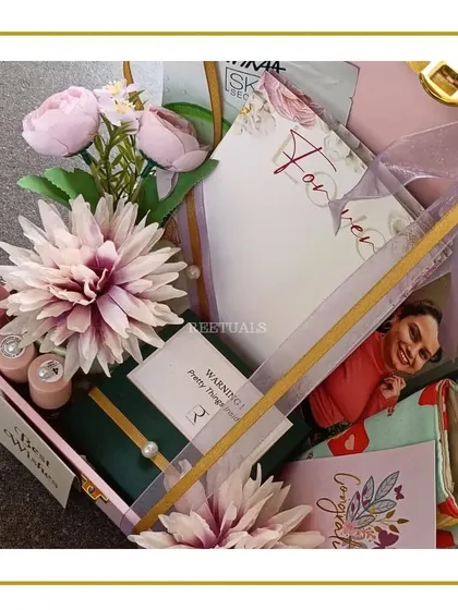 A thoughtfully curated engagement hamper for a best friend. This pink trunk box is filled with personalized items, a photo, skincare, and a heartfelt note to celebrate her new chapter.