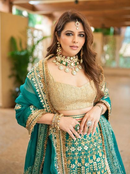 A close-up of the festive look, showing the beautiful teal tones in the outfit complemented by warm, shimmery makeup and a soft, glowing complexion.