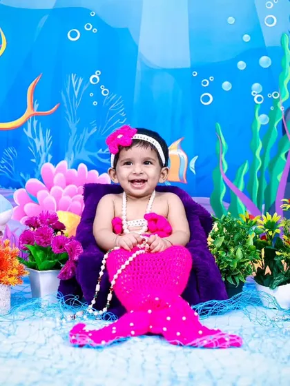 A full view of the pink mermaid theme, complete with treasure chests and sea plants.