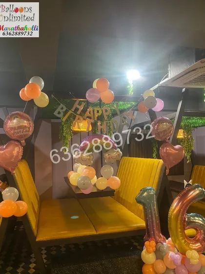 A simple yet beautiful setup for a sweet sixteen. We decorated this cafe corner with pastel-colored balloon bunches, heart-shaped foils, and a standing '16' number arrangement to make the celebration special.