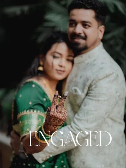 "Engaged!" This playful and happy photo perfectly captures the excitement of the moment. Her showing off the ring with a fun gesture adds a touch of modern personality to their traditional engagement shoot.