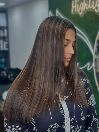 Sleek, straight, and highlighted. This look shows how our balayage technique can look just as stunning on straight hair, with flawless, vibrant blends.