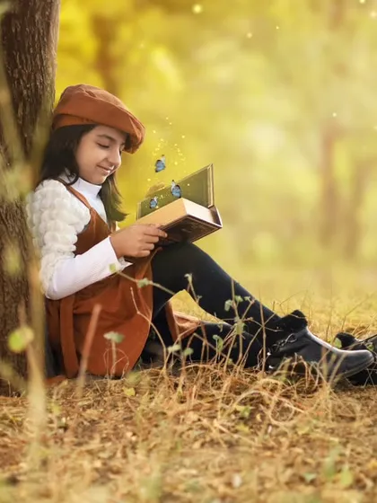 My own beti's 7th birthday shoot. I imagined a dreamy, golden-hour session for her, and here she is, lost in a magical book under a tree.