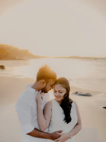 There's something magical about the golden hour light on a quiet Mumbai beach. For this pre-wedding session, we kept it simple with white outfits, letting the warm sunset and the couple's gentle interaction create a soft, romantic atmosphere.
