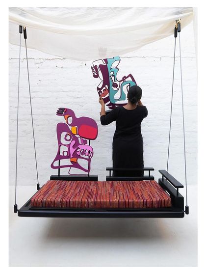 Me arranging the modular backrests on the 'Kaleidochaos' swing, demonstrating its interactive and customizable design.