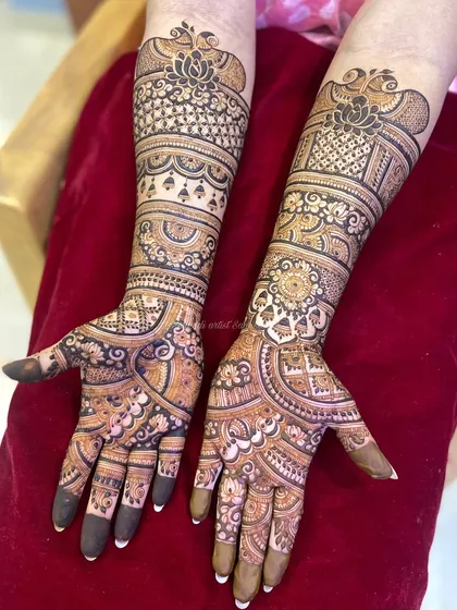 A full view of the engagement mehendi for the same client, showing the intricate patterns on both arms.