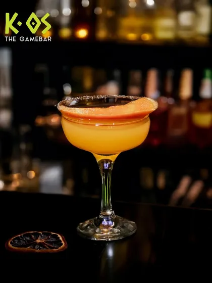 Press play on fun and sip the chaos. This beautifully garnished yellow cocktail is a game-changer.