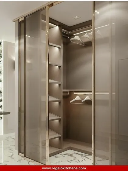 An L-shaped closet with frosted glass sliding doors. This design offers a hint of what's inside while maintaining a clean, uncluttered appearance.