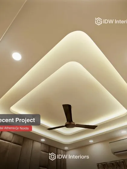 An elegant false ceiling design with soft, indirect lighting that creates a calm and luxurious atmosphere in this master bedroom.