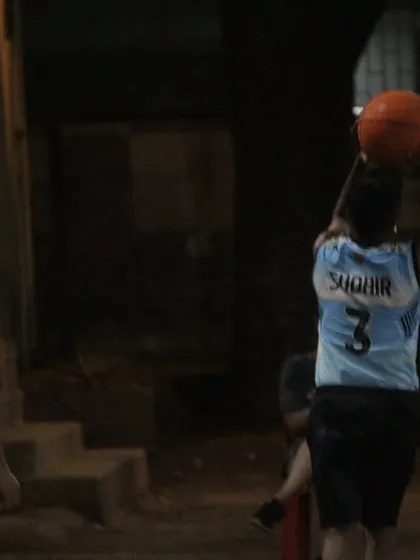 A player takes a shot under the watchful eye of a defender. Every point is hard-earned in these competitive games.
