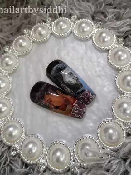 A press-on set celebrating the movie RRR, with hand-painted portraits of the main characters.