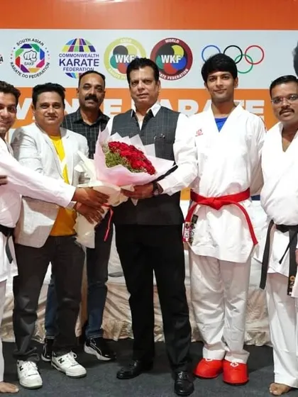 Welcoming guests and officials at the Advance Karate Kumite Seminar in Pune, Maharashtra. These seminars are crucial for disseminating advanced fighting techniques and strategies to a wider group of athletes and coaches.