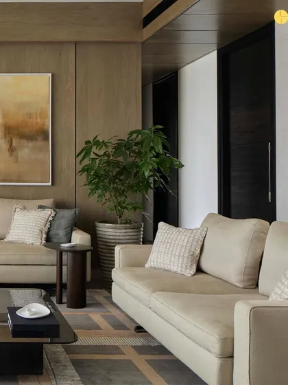 Another view of the living space in 'Pad by the Bay.' The layout is carefully planned to feel layered and inviting, with comfortable sofas and armchairs arranged to encourage conversation while maintaining a connection to the views outside.