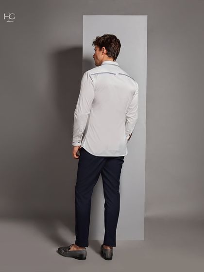 The back of the detailed white shirt, showing the continuation of the subtle piping across the yoke. Every angle is considered in my designs.