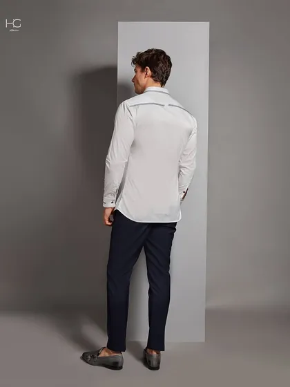 The back of the detailed white shirt, showing the continuation of the subtle piping across the yoke. Every angle is considered in my designs.