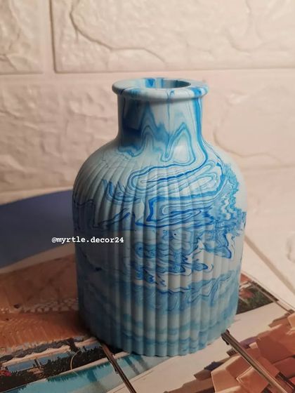 Our new Jesmonite vase, shown here in a beautiful blue marble pattern. The ribbed texture and classic shape make it a timeless piece for holding your favorite fresh or dried flowers.