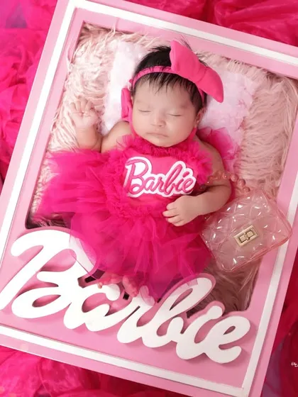 The complete Barbie look! This wider shot shows our attention to detail, including miniature accessories like a suitcase and handbag to complete the creative newborn setup.