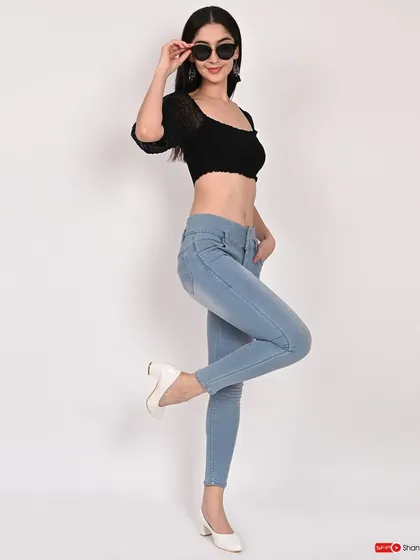 A full-body shot showcasing a casual look with a black crop top and light-wash jeans. This type of image is great for demonstrating how individual pieces can be styled.