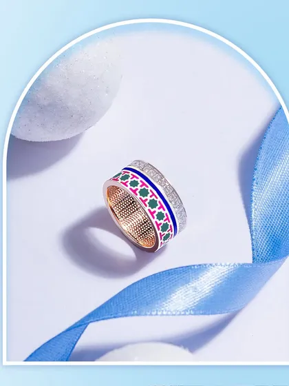Natural diamonds and French enamel are entwined with finesse and charm in this intricate thumb ring. The detailed meenakari-style pattern makes it a unique statement of wearable art.