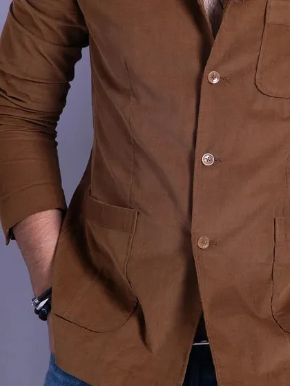 A front view of the brown corduroy blazer, highlighting its casual structure and button stance. It's a versatile piece for smart-casual dressing.