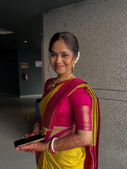 A beautiful smile from my bride, ready for her vidhi ceremony in a vibrant yellow and pink saree with minimal, elegant gold jewellery.